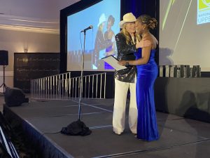 Jodi presents Carlini Family Scholarship to Lizzy Nioyke